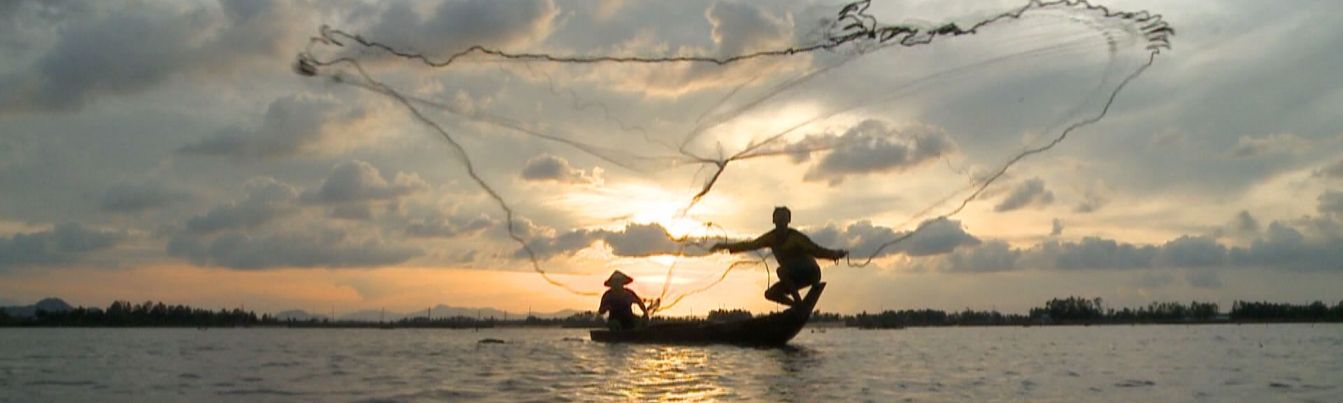 Fishermen are casting a net on the riverbank of Cuu Long River